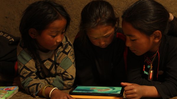 Kindergarten students exploring HRK on tablets in the classroom